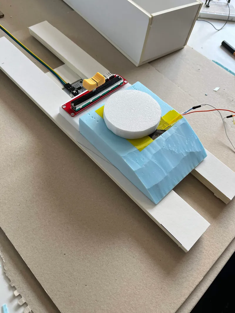 The colour picker prototype: white dial on a slider rail with a light blue base